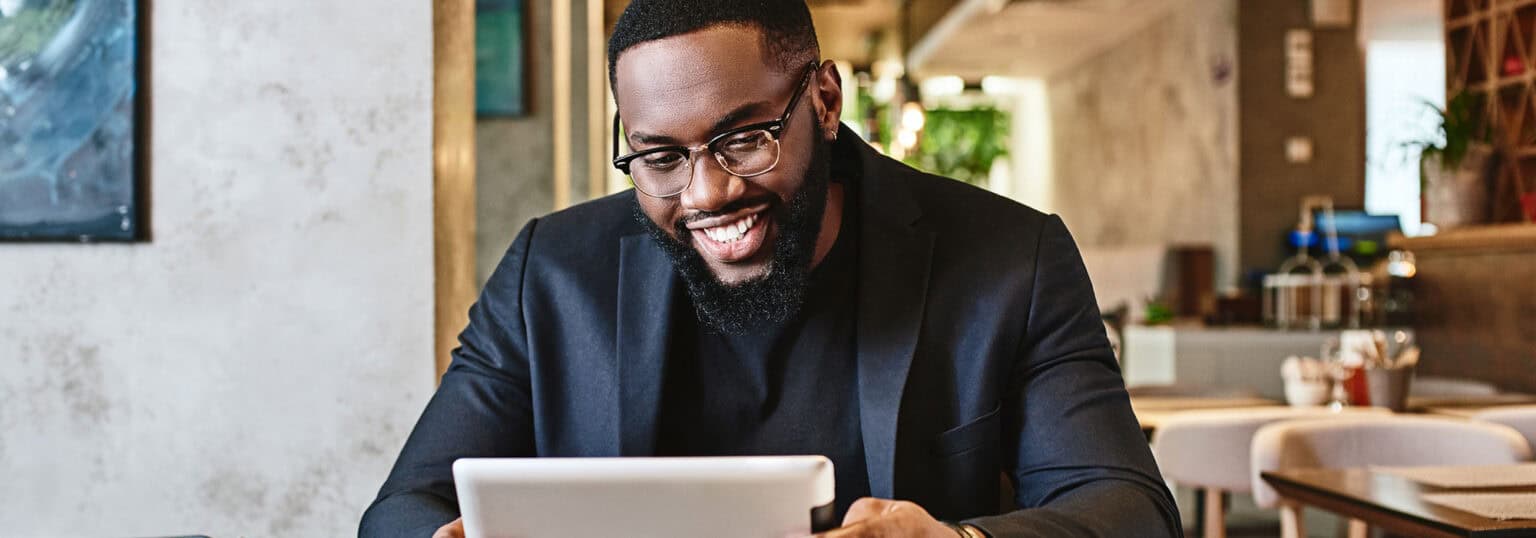 Smiling man looking at financial aid paperwork