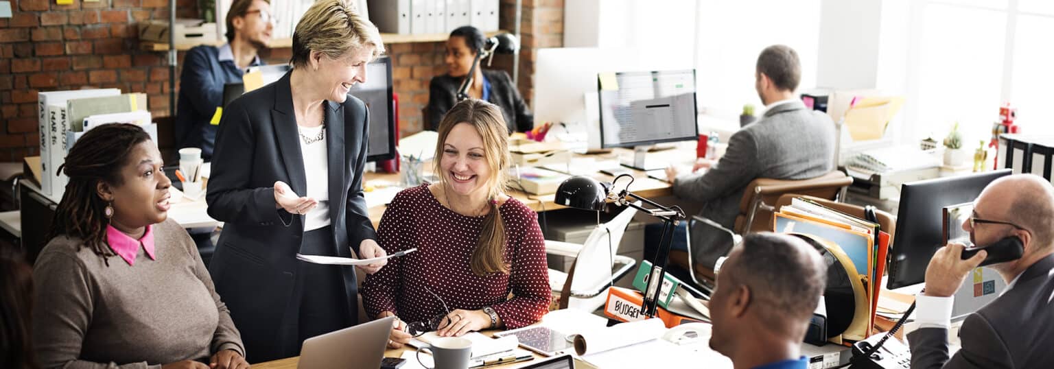 A group of people working in an office setting.