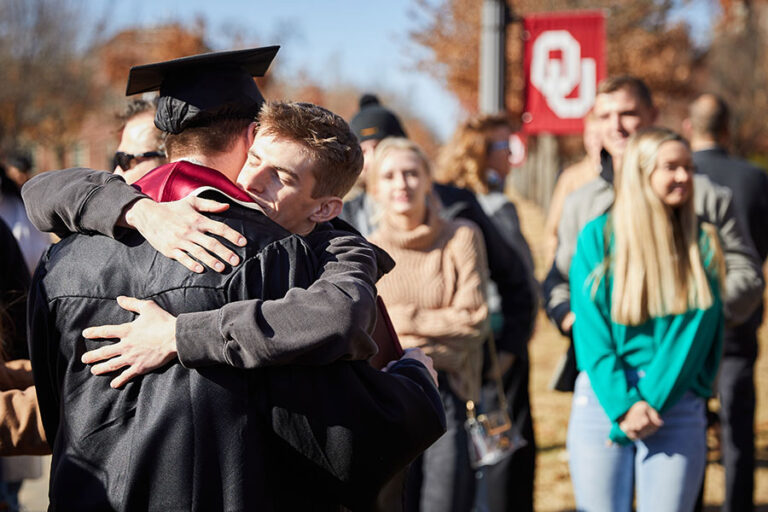 Graduating students hugging each other