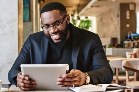 Smiling man looking at financial aid paperwork