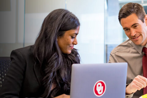 Man and woman looking at computer