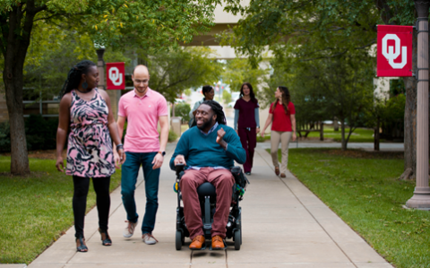 students on the south oval, one of the students is in a wheelchair