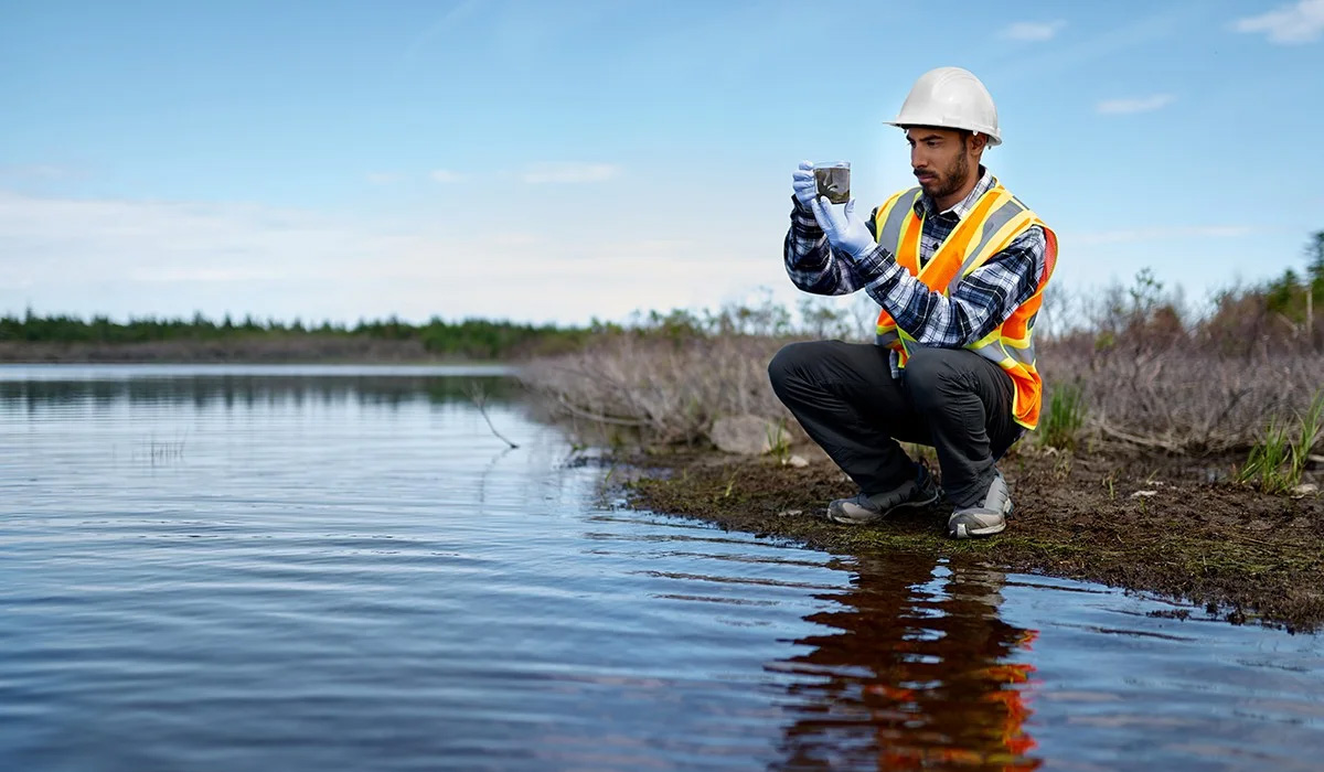 analyst gathering and studying water sample