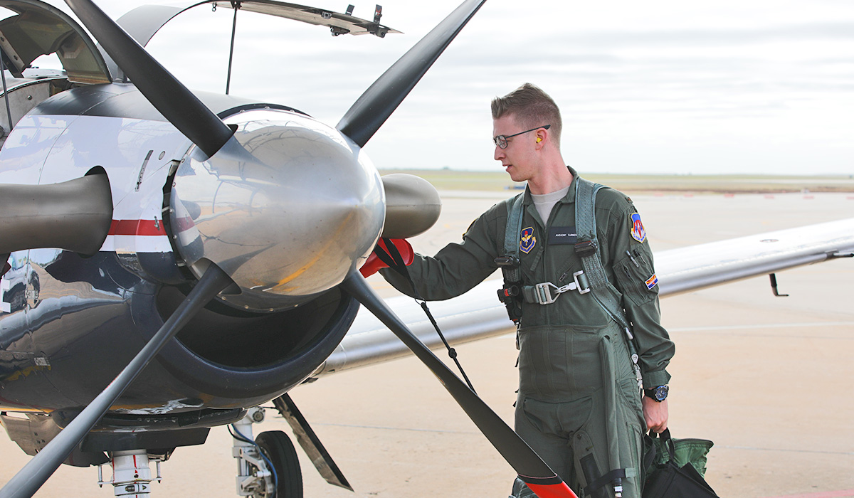 pilot standing next to plane