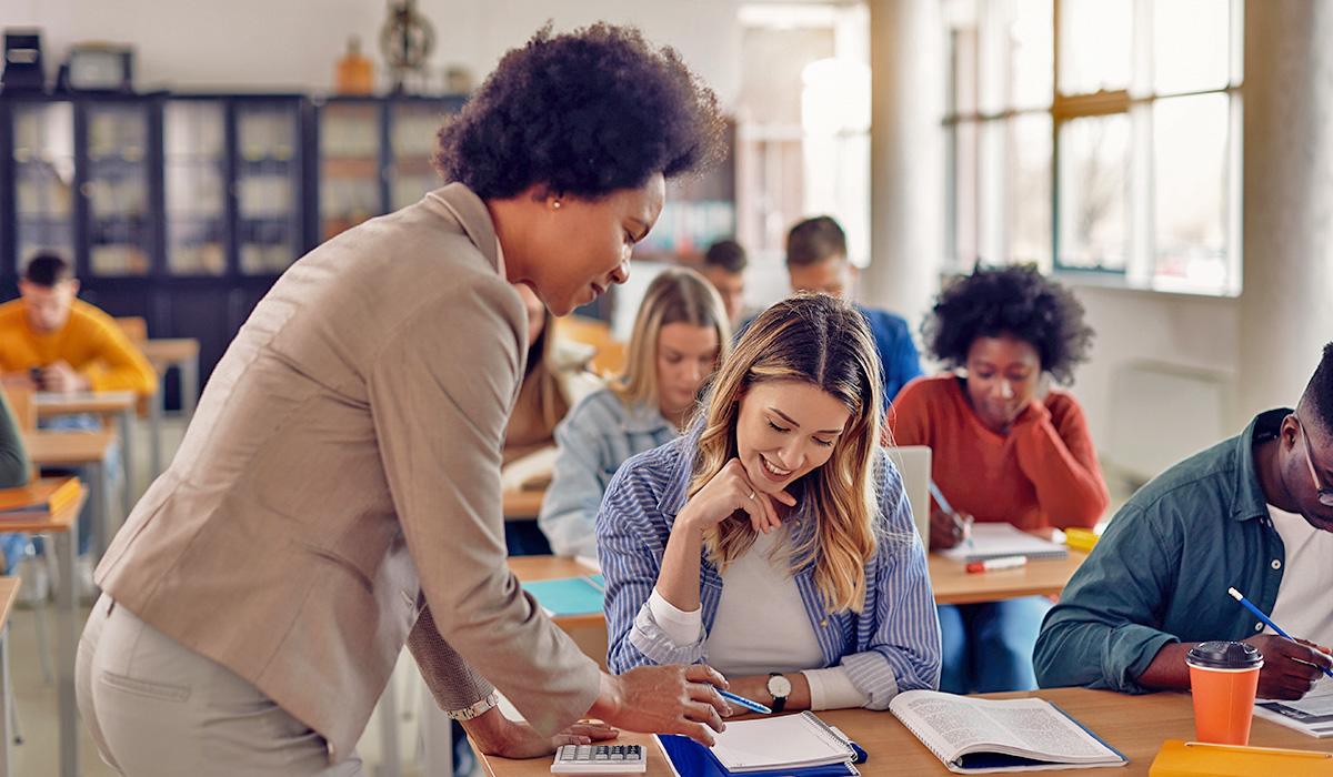 teacher working with students in classroom