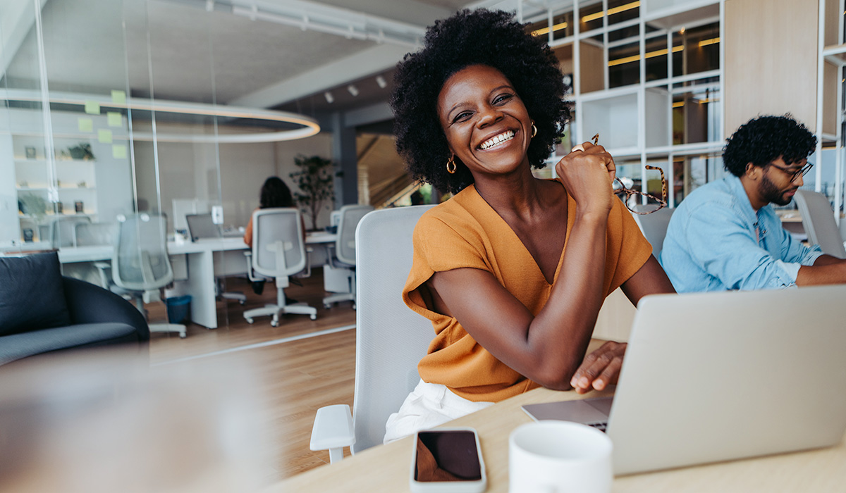 Happy entrepreneur at her desk