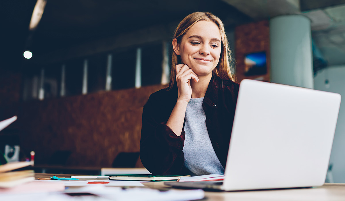 finance professional working at her desk with a laptop