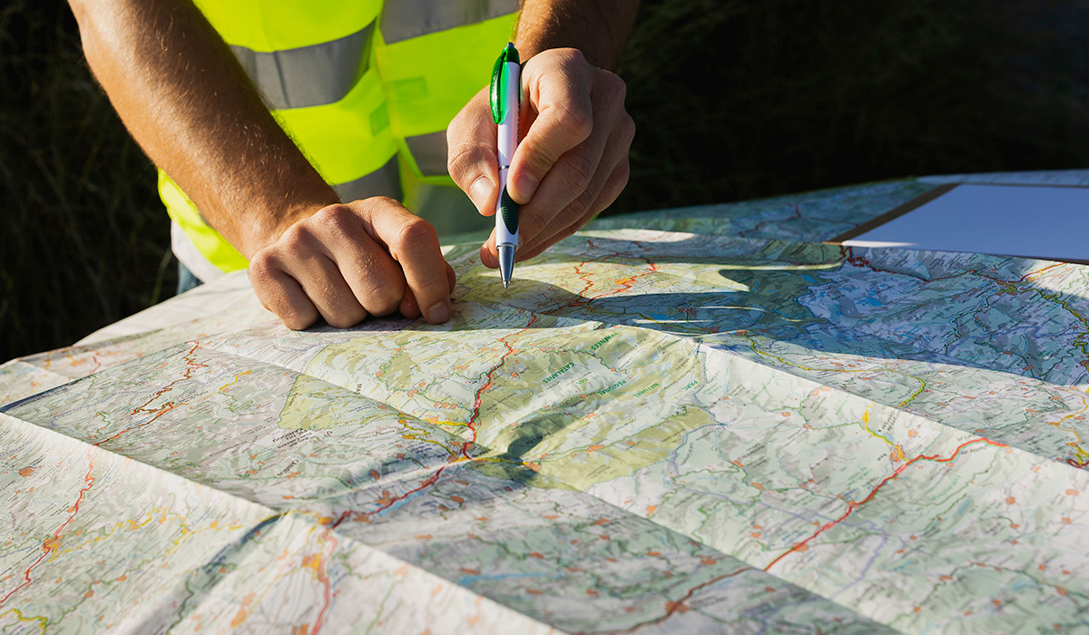 geospatial technologist studying a map