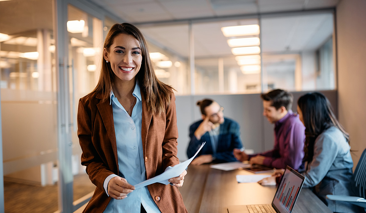 young female professional about to present to 3 co-workers