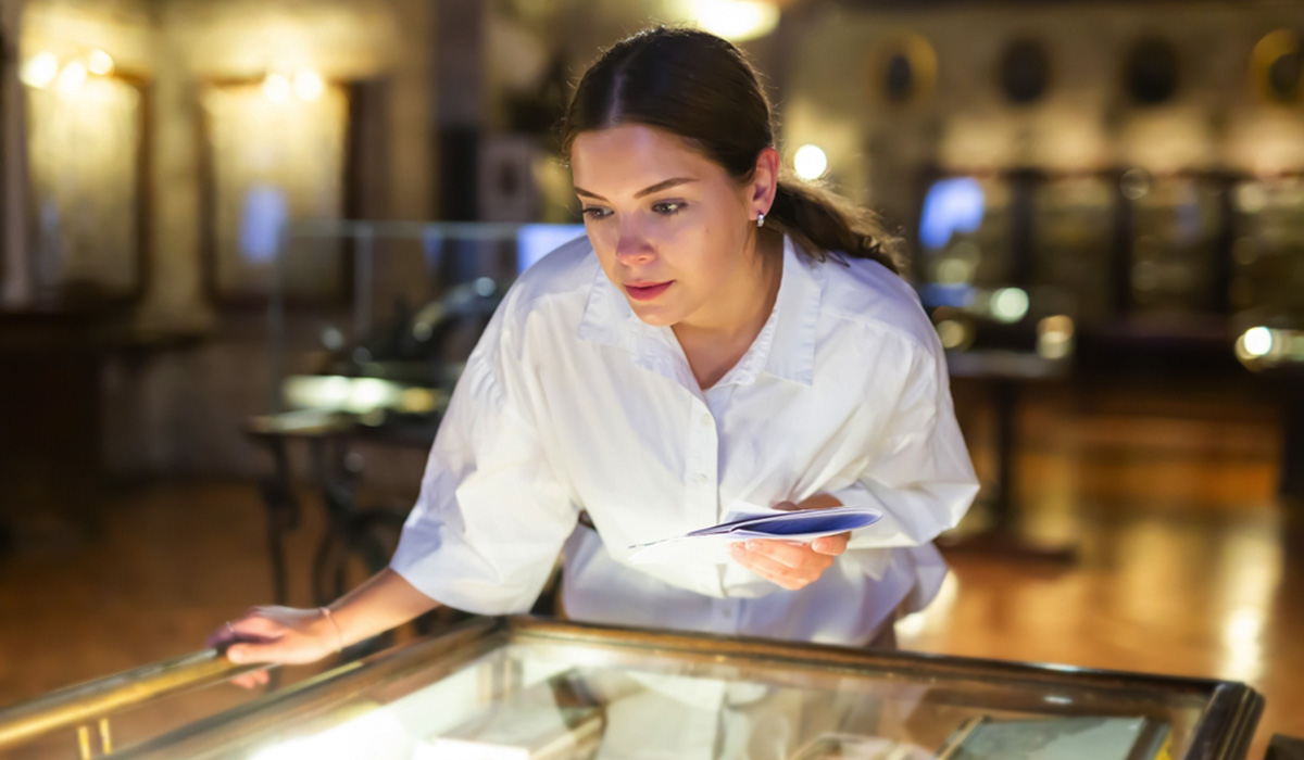 Women studying collection display in museum