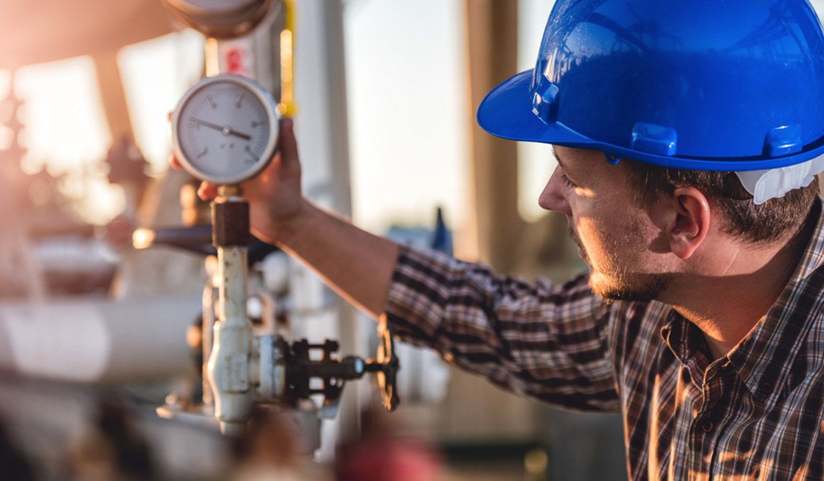 Natural gas engineer checking pressure gauges