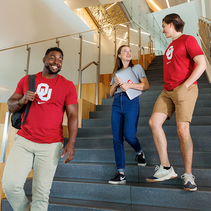 group of 3 students descending a flight of stairs