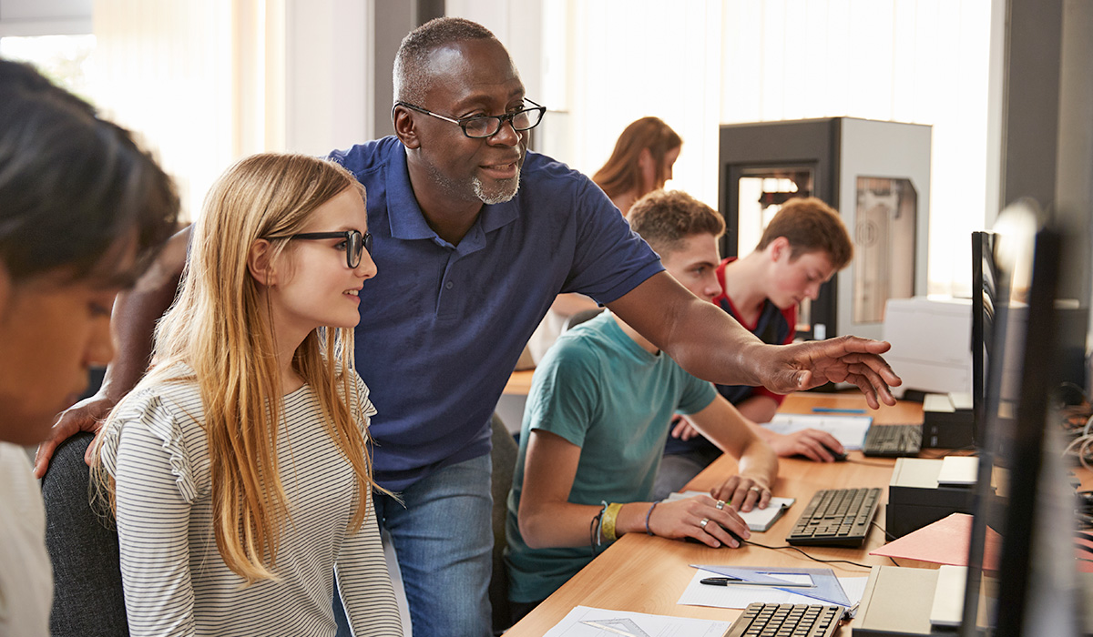 teacher working with students