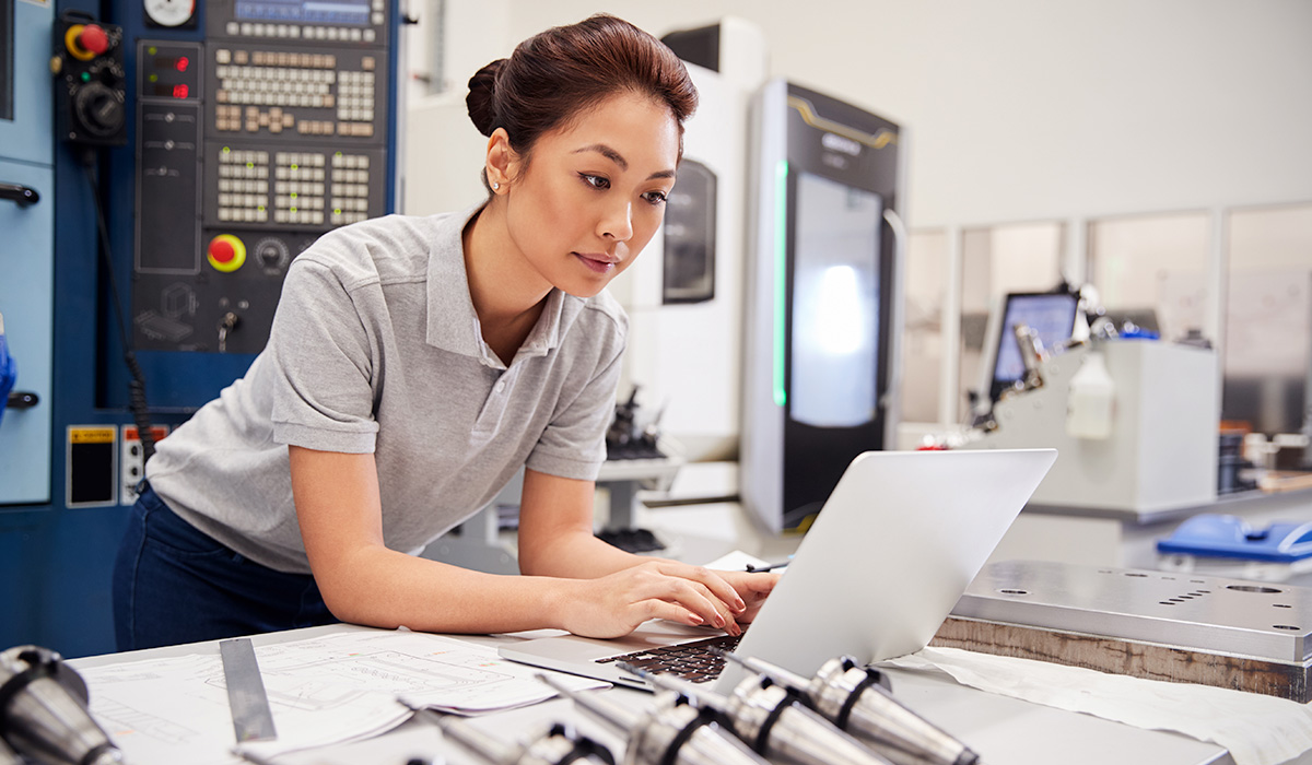 engineer working on project plans at her desk