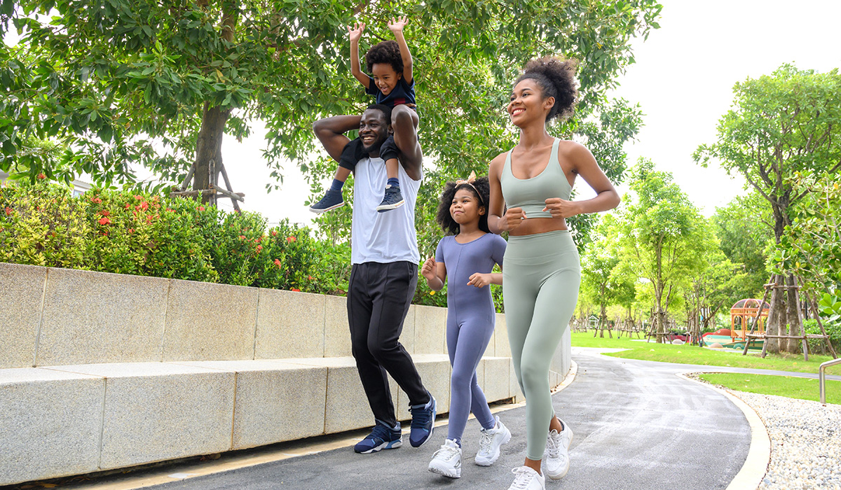 family on jogging path in a park