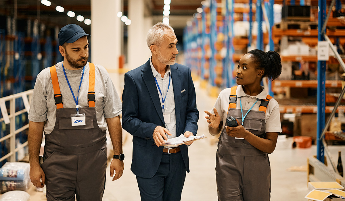 management team meeting in a warehouse