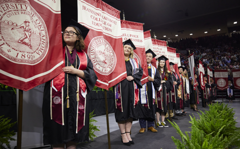 banner carriers in line at commencement