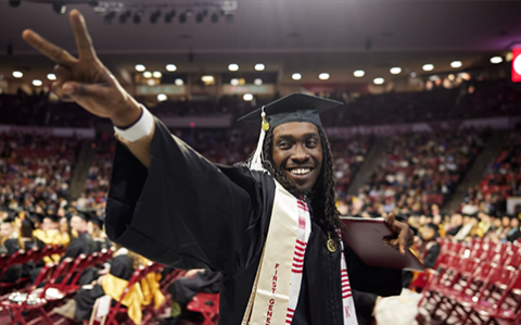 Smiling first gen student at commencement