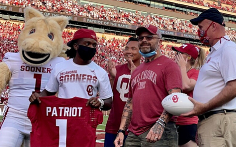 OU Online Student being awarded Patriot of the Game