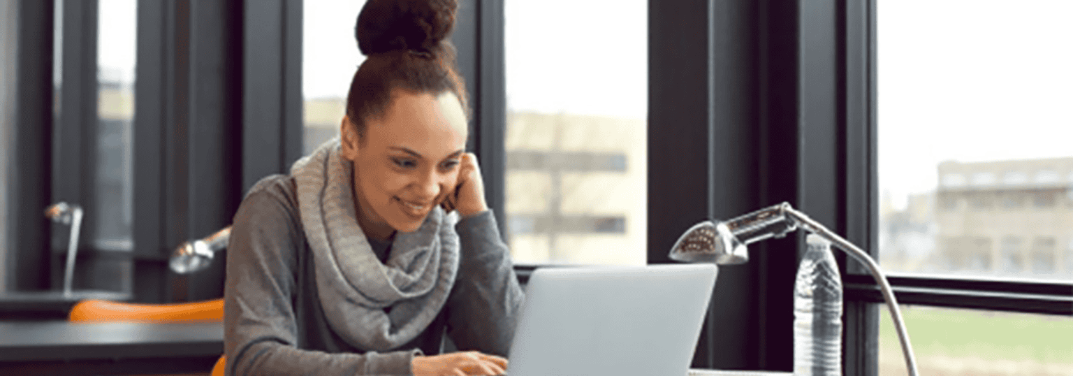 Student at her desk using laptop