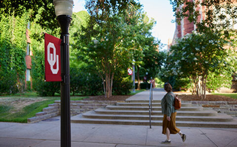 photo of OU campus as student with backpack walks by