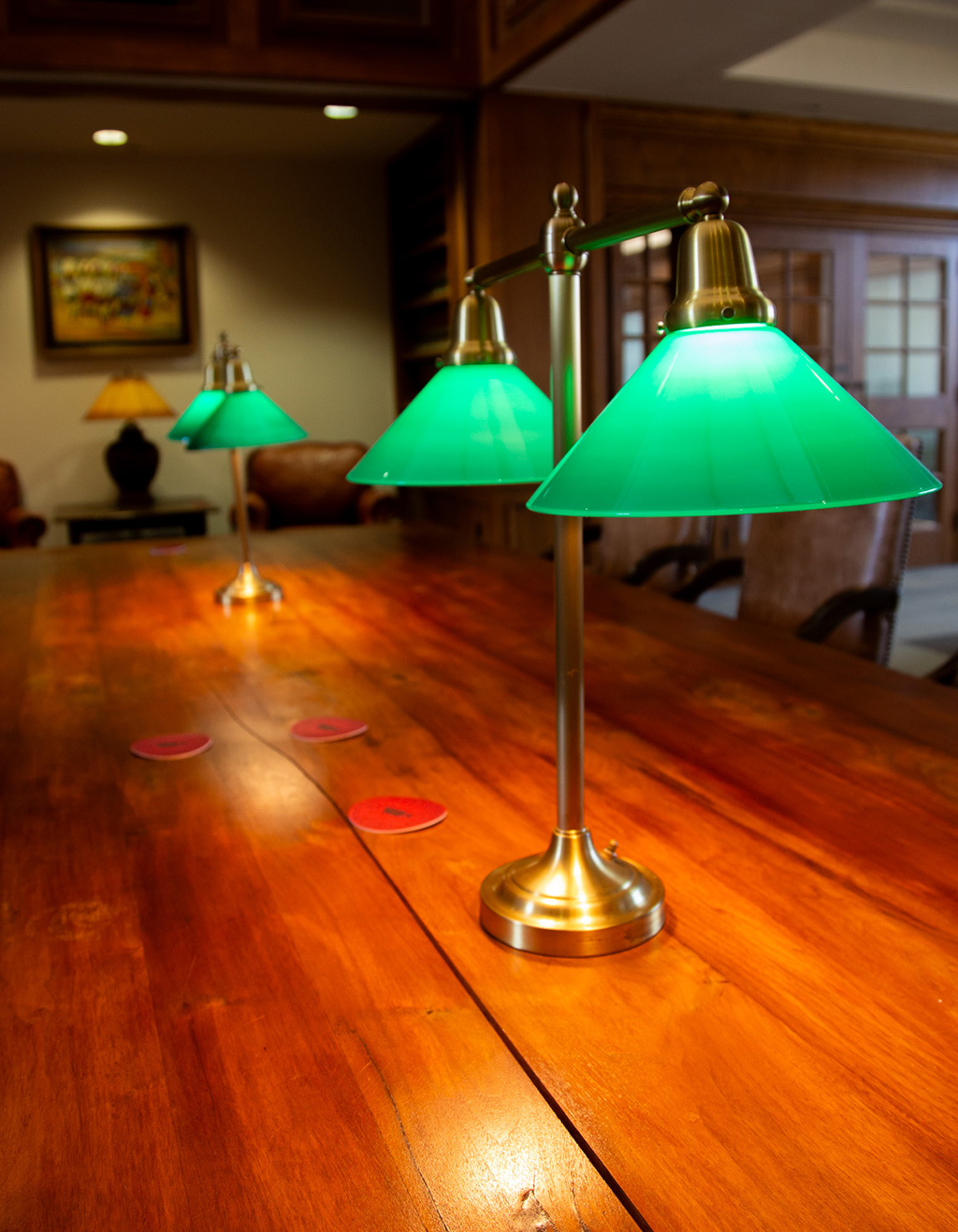 Table with green reading lamps in the OU College of Law Library