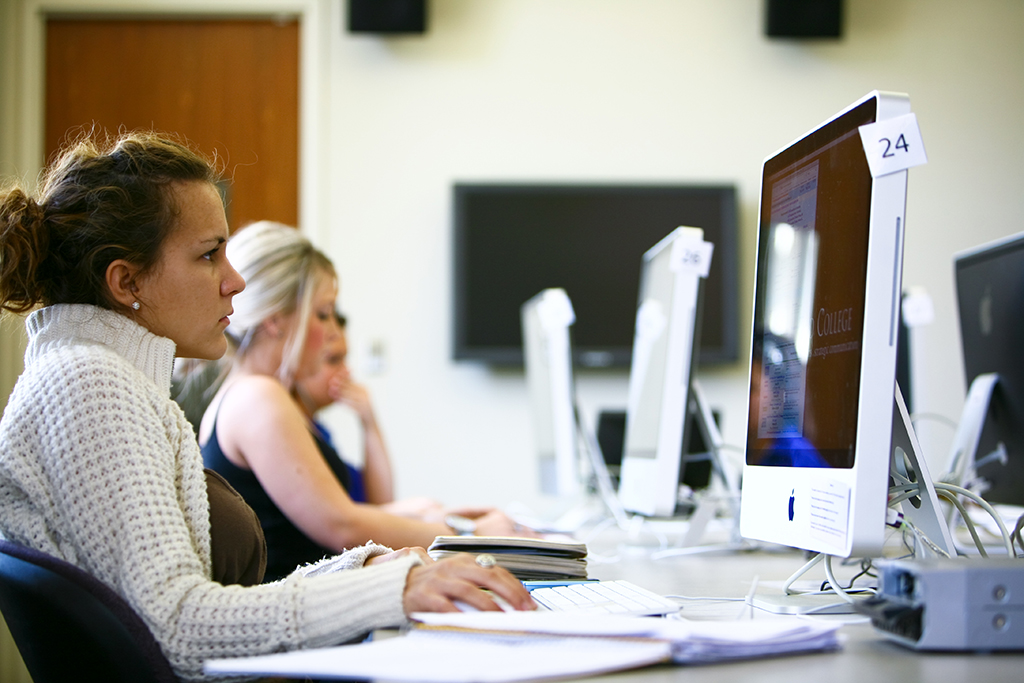 graduate students working on course work in a computer lab