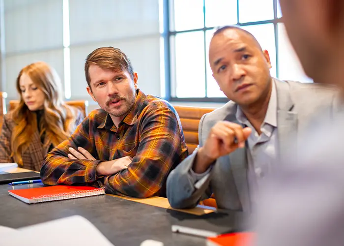 People around a conference table talking