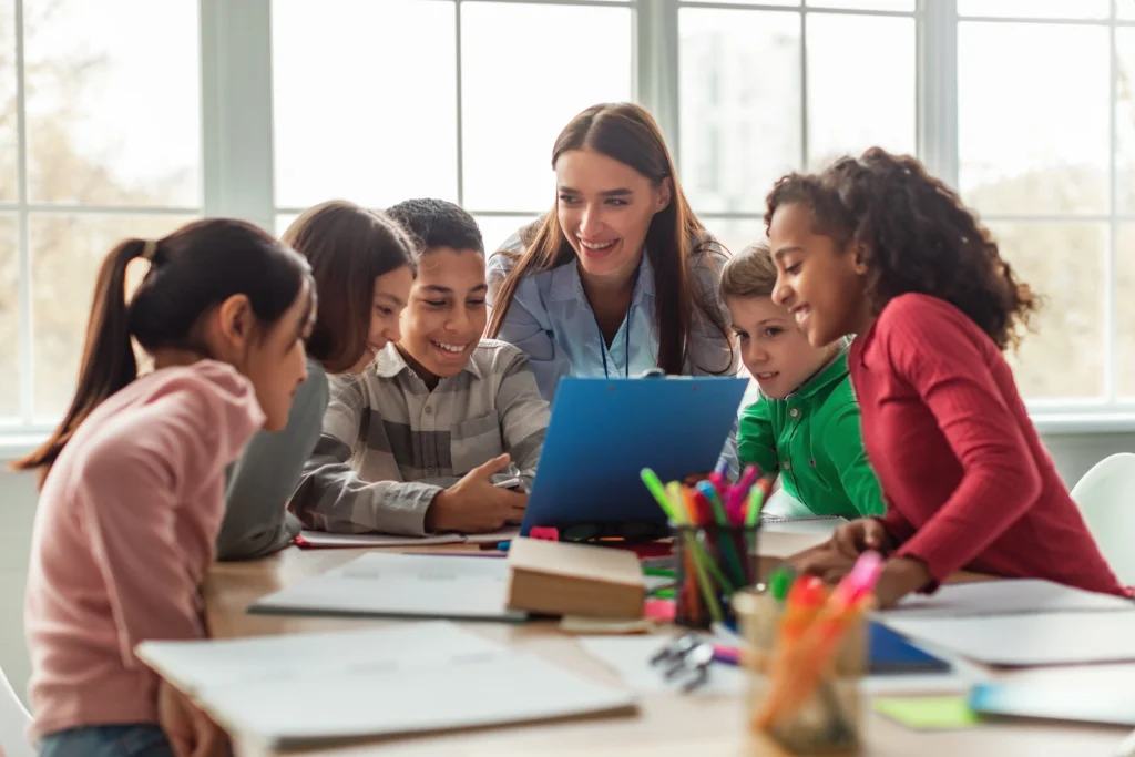 Group of young children gathered around a teacher