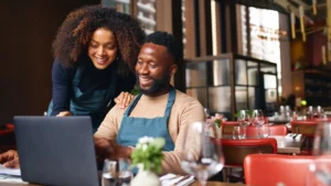 Happy entrepreneur couple at discussing data at their desk