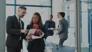 International Law Professionals standing in an office and using a table to discuss a case