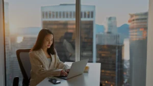 International Law Professional working at her desk using a laptop