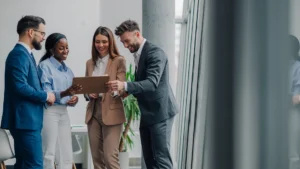 Four business leaders viewing client files