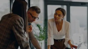 A group of people analyzing information in an office setting.